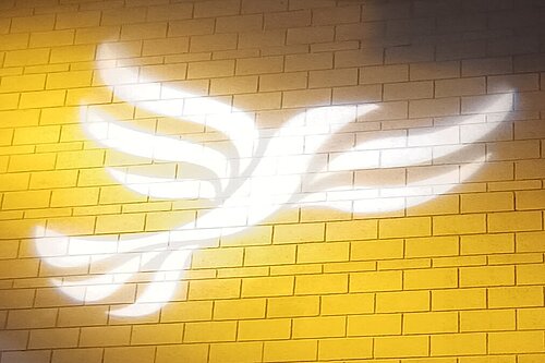 Lib Dem logo bird projected on blockwork